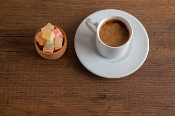 Colorful Turkish delight and Turkish coffee on a wooden background,top view