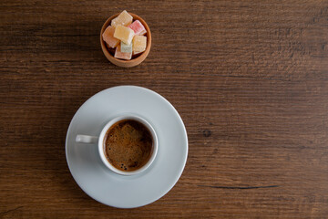 Colorful Turkish delight and Turkish coffee on a wooden background,directly above