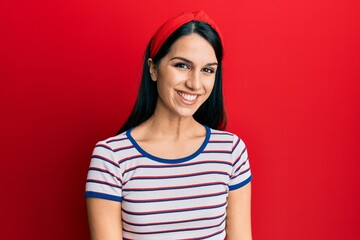 Young hispanic woman wearing casual clothes looking positive and happy standing and smiling with a confident smile showing teeth