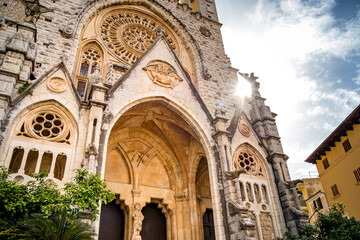 Frog view photography of the entrance of gothic revival style cathedral of S&oacute;ller, called parroquia de sant bartomeu de S&oacute;ller, located in the old town of Soller, Mallorca