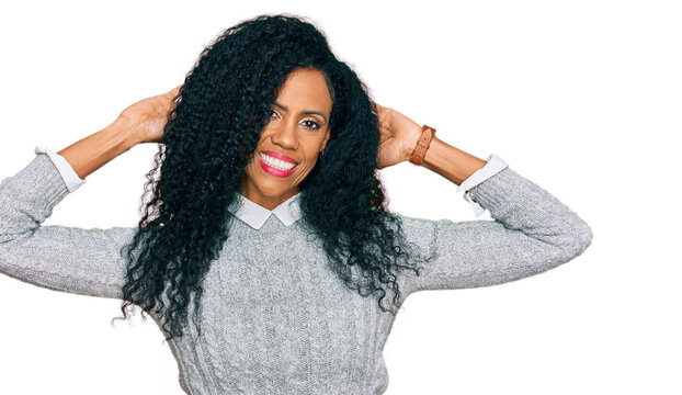 Middle age african american woman wearing casual clothes relaxing and stretching, arms and hands behind head and neck smiling happy