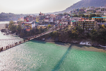 lakshman jhula iron suspension bridge over ganges river from flat angle