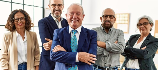 Group of middle age business workers smiling happy standing with arms crossed gesture at the office