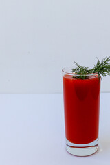 tomato juice in a clear glass with dill