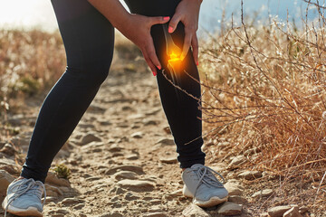 Putting an end to her workout. Shot of an unrecognizable woman exercising outdoors with a highlighted knee injury.