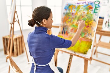 Young latin woman smiling confident drawing at art studio