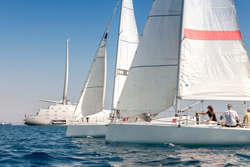 Sailboats near Cyprus coast, super yacht in background