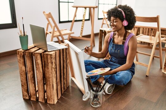 Young african american woman having online drawing class at art studio