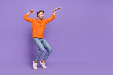 Fototapeta na wymiar Full length profile side photo of overjoyed man make egyptian dance fooling around isolated on violet color background