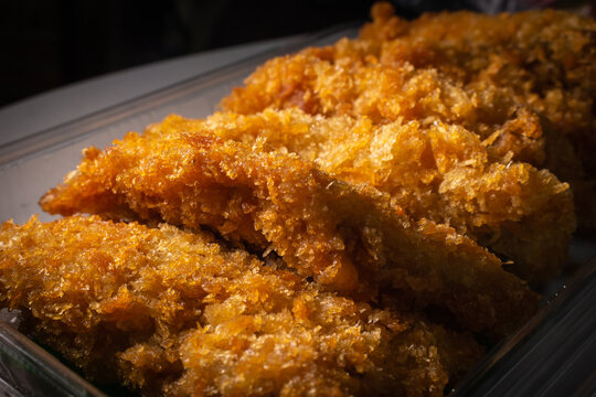 A pack of Japanese fried chicken tenders on the table. Takeout fast-food concept image.