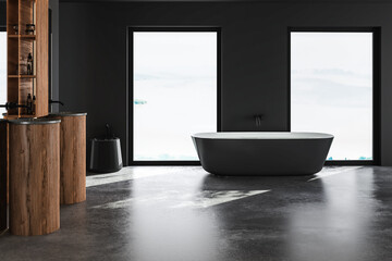 Beautiful black bathtub in centre of dark grey bathroom and double sinks. Minimalist design of modern bathroom. 3D rendering