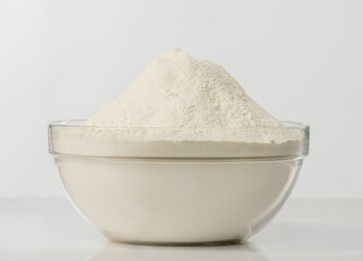 flour in a transparent bowl on a white background