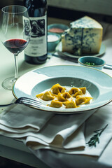 Italian Ravioli, Roquefort Cheese, Blue Cheese, Glass of Red Wine on Served Table, Restaurant food