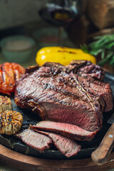 T-bone Steak, Grilled Garlic, Tomatoes, Vegetables, Red Wine on Served table, Restaurant food