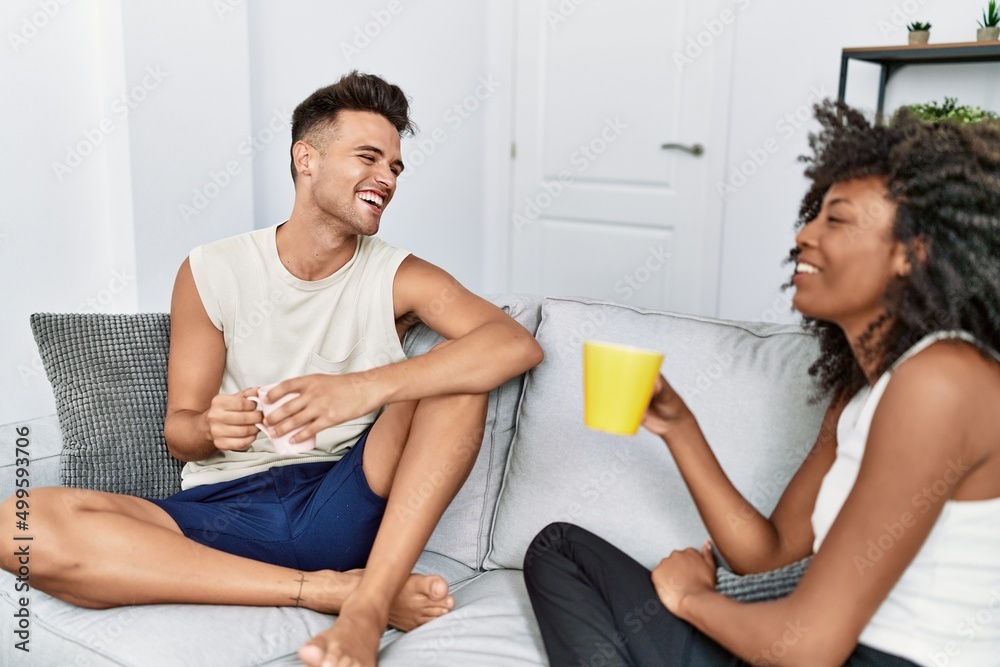 Canvas Prints man and woman couple drinking coffee sitting on the sofa at home