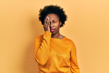 Fototapeta na wymiar Young african american woman wearing casual clothes yawning tired covering half face, eye and mouth with hand. face hurts in pain.