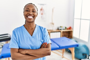 Black woman with braids working at pain recovery clinic happy face smiling with crossed arms...