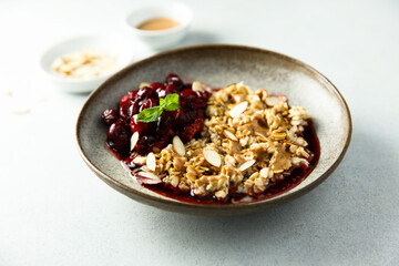 Healthy oatmeal porridge with cherries and almond