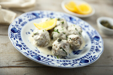 Traditional homemade meatballs with cream, capers and lemon