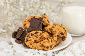 Chocolate cookies on white wooden table with milk. Chocolate chip cookies shot