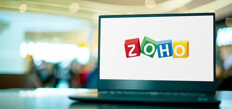 Laptop computer displaying logo of Zoho