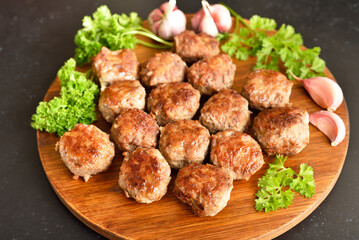 Fried meatballs on cutting board