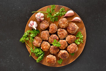 Roasted meatballs on cutting board