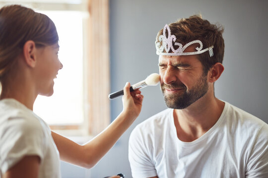 I love that Daddy plays dress up with me. Cropped shot of a little girl putting makeup on her father.