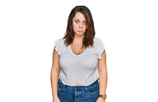Young plus size woman wearing casual white t shirt depressed and worry for distress, crying angry and afraid. sad expression.