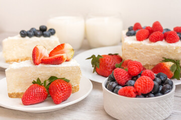 Classic sliced cheesecake with fresh berries - strawberry, raspberries and  blueberries, close up. No baked, Tasty cake with cheese  