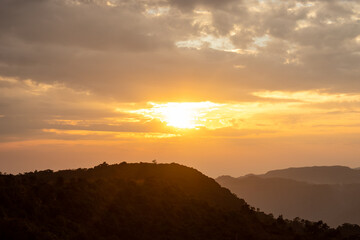 dramatic sunset orange sky over mountain shadow at morning from flat angle