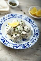 Traditional homemade meatballs with cream, capers and lemon