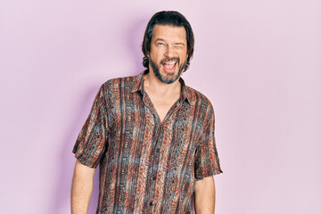 Middle age caucasian man wearing casual clothes winking looking at the camera with sexy expression, cheerful and happy face.