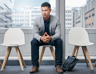 Just waiting to be called. Shot of a young businessman sitting in a waiting room.