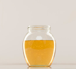 jar with honey on white background