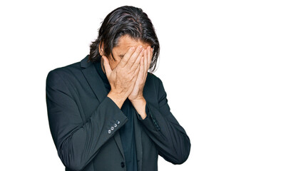 Middle age handsome man wearing business clothes with sad expression covering face with hands while...