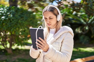 Young woman using touchpad at park