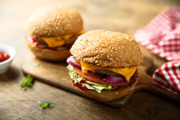 Traditional homemade cheeseburgers with pickles