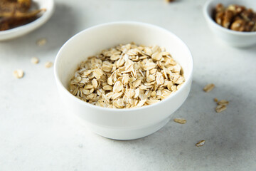 Healthy rolled oats in a white bowl