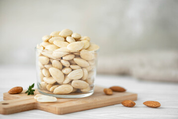 peeled large almonds in a glass bowl