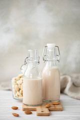 Obraz na płótnie Canvas homemade vegetable almond milk in glass bottles