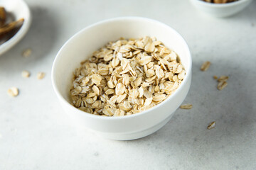 Healthy rolled oats in a white bowl