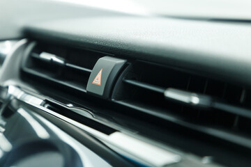 Obraz na płótnie Canvas Emergency light stop button in a luxury car. Warning button. Close-up.