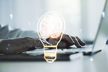 Creative light bulb illustration with human brain and with hands typing on computer keyboard on background, future technology concept. Multiexposure
