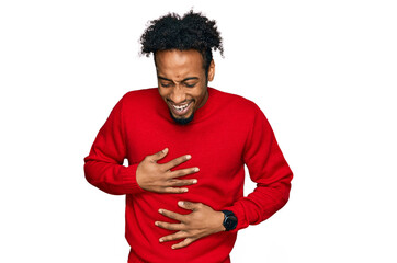 Young african american man with beard wearing casual winter sweater smiling and laughing hard out...
