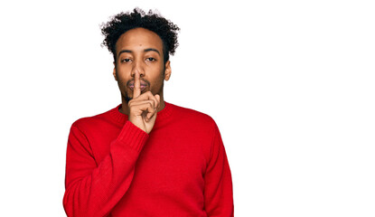 Young african american man with beard wearing casual winter sweater asking to be quiet with finger on lips. silence and secret concept.