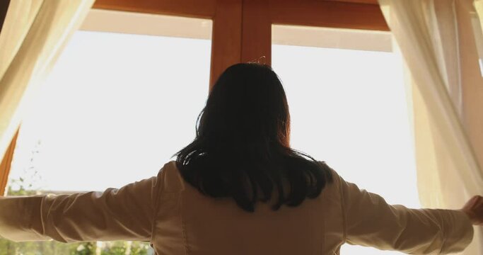 4K Video slow motion asian woman open the door on the morning with sunrise. Concept for new day fresh and happiness.