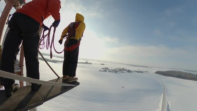 a girl jumps from a tower, a woman falls from a height, rope jumping