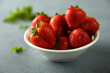Fresh ripe strawberry in a white bowl