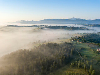 Morning mist in Ukrainian Carpathian mountains. Aerial drone view.